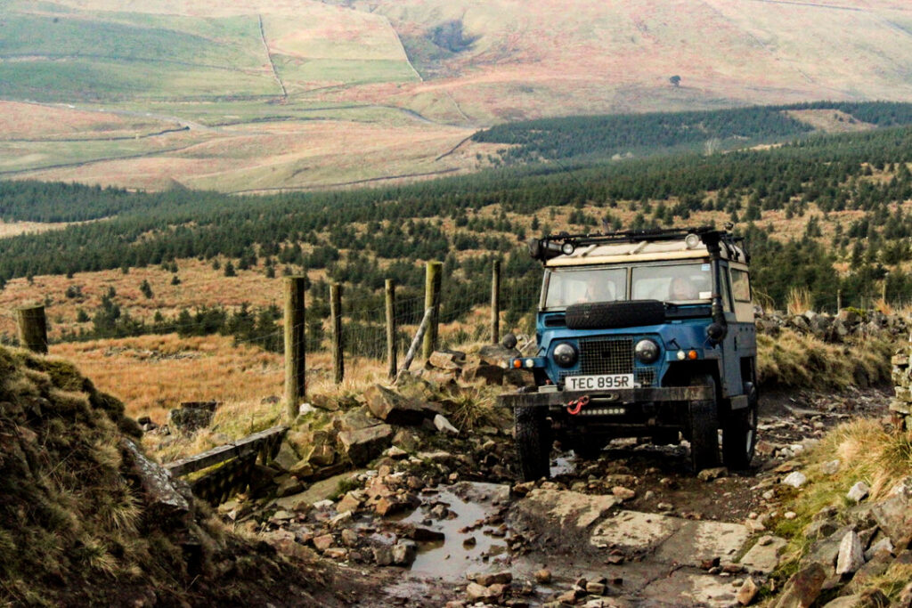 Single off-road 4x4 vehicle driving a scenic green lane in the UK, representing an All Terrain UK Affiliate Member exploring responsibly.